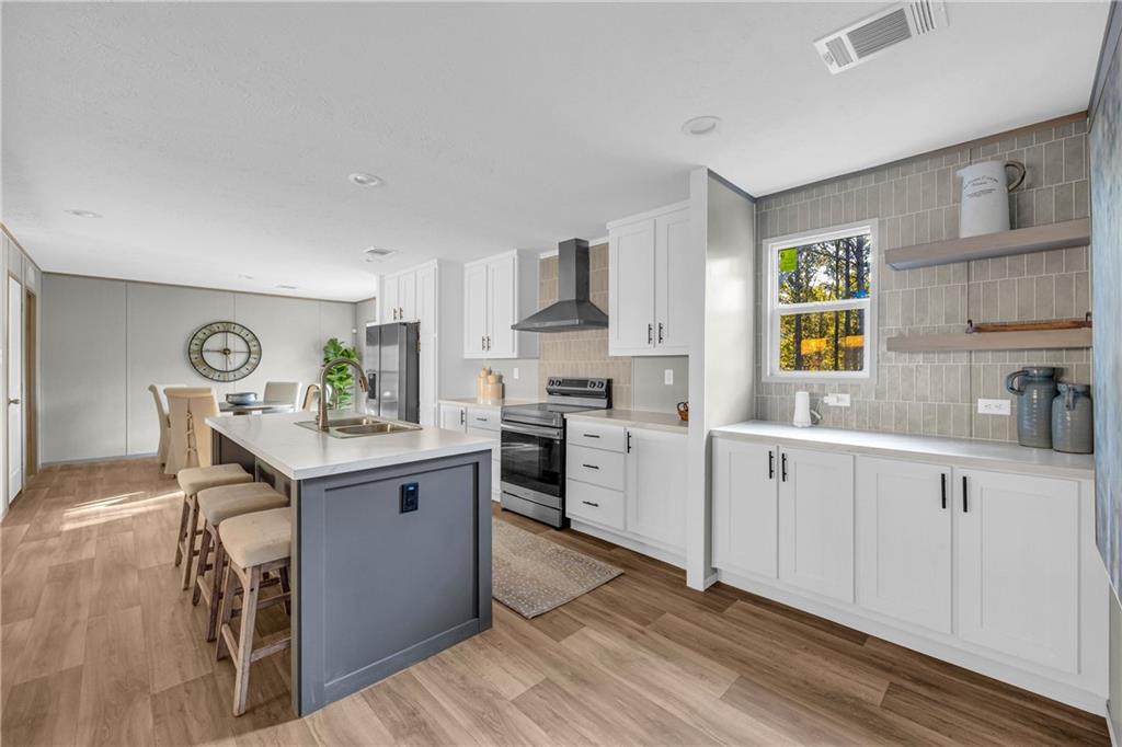 946 Essic Road Ball Ground, GA 30107 - Photo 11 of 45 a kitchen with stainless steel appliances granite countertop a sink stove and refrigerator
