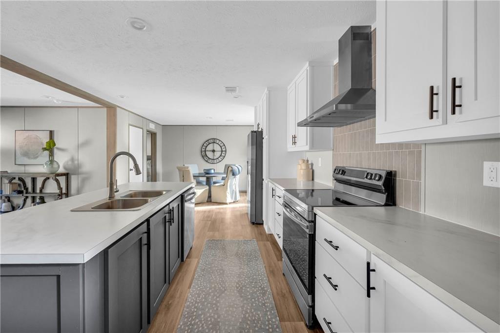 946 Essic Road Ball Ground, GA 30107 - Photo 12 of 45 a kitchen with stainless steel appliances granite countertop a sink stove and cabinets