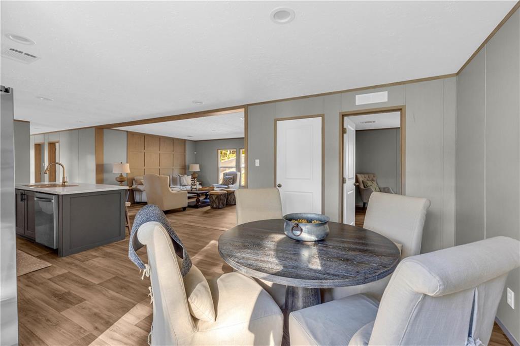 946 Essic Road Ball Ground, GA 30107 - Photo 15 of 45 a view of a dining room with furniture and wooden floor