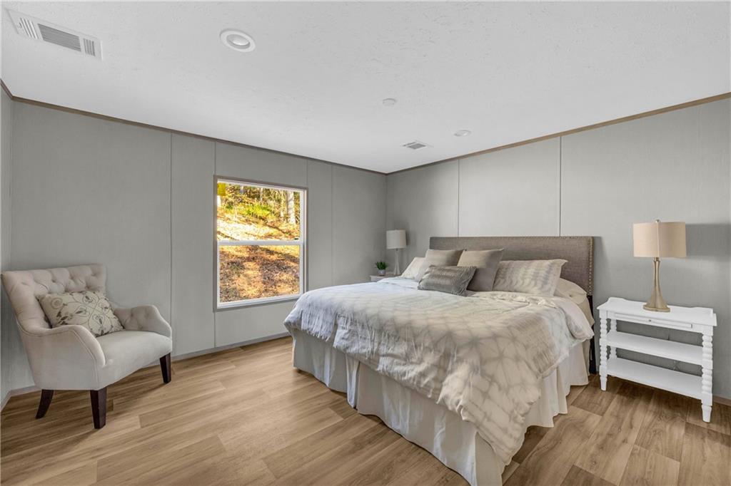 946 Essic Road Ball Ground, GA 30107 - Photo 17 of 45 a bedroom with bed and window