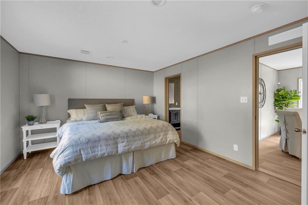 946 Essic Road Ball Ground, GA 30107 - Photo 18 of 45 a bedroom with a bed and wooden floor