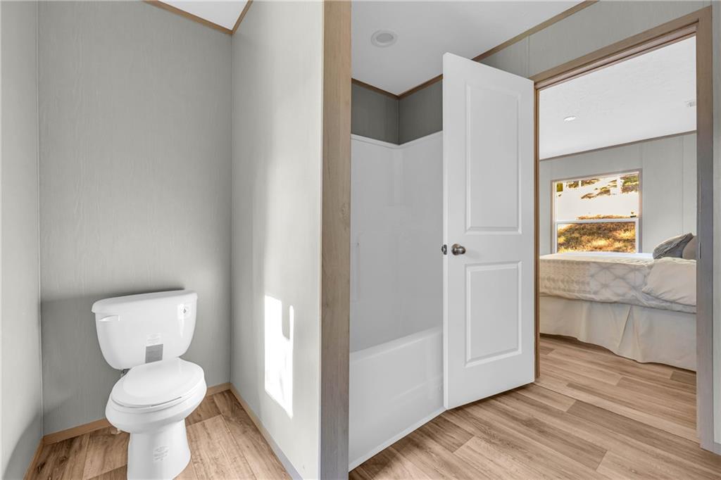 946 Essic Road Ball Ground, GA 30107 - Photo 23 of 45 a bathroom with a toilet sink and shower