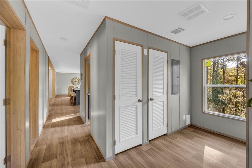 946 Essic Road Ball Ground, GA 30107 - Photo 30 of 45 a view of a hallway with wooden floor and cabinet