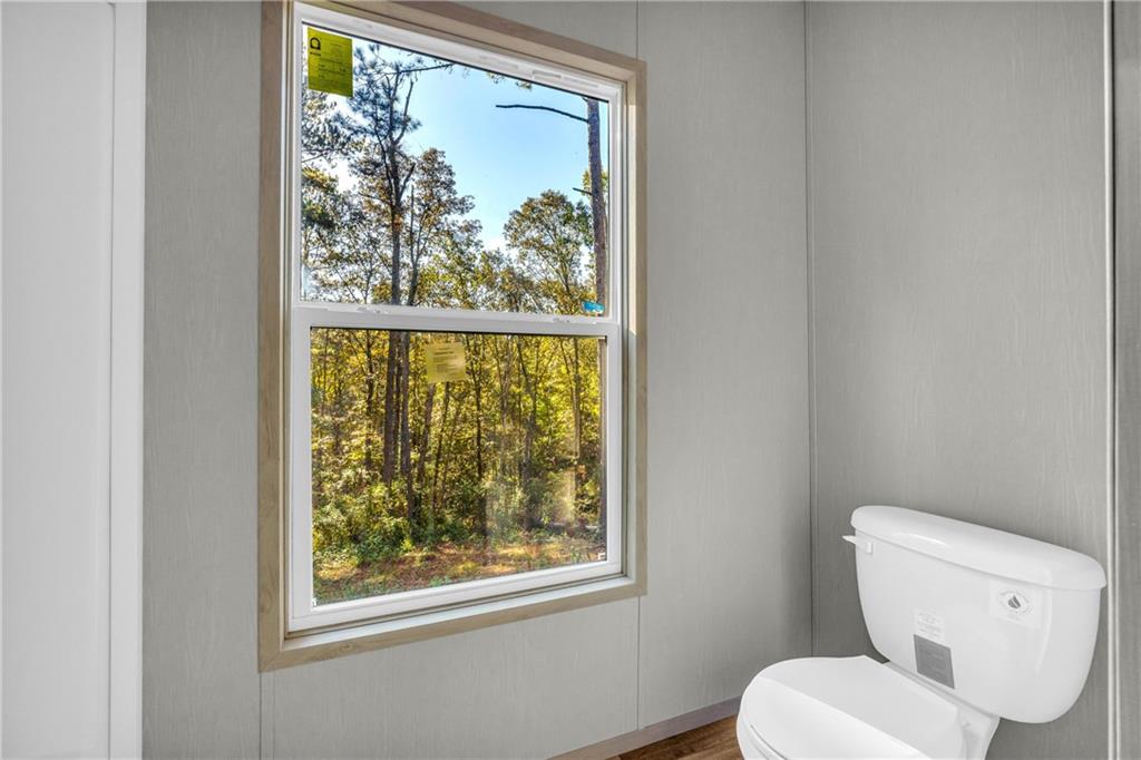 946 Essic Road Ball Ground, GA 30107 - Photo 33 of 45 a white toilet sitting next to a window