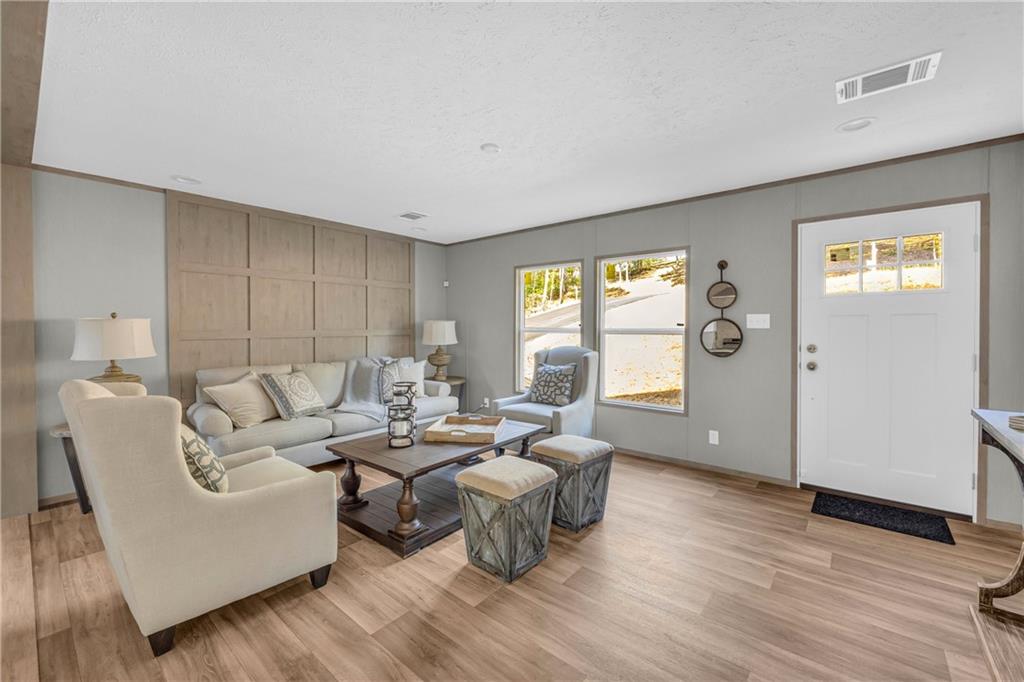 946 Essic Road Ball Ground, GA 30107 - Photo 5 of 45 a living room with furniture and wooden floor