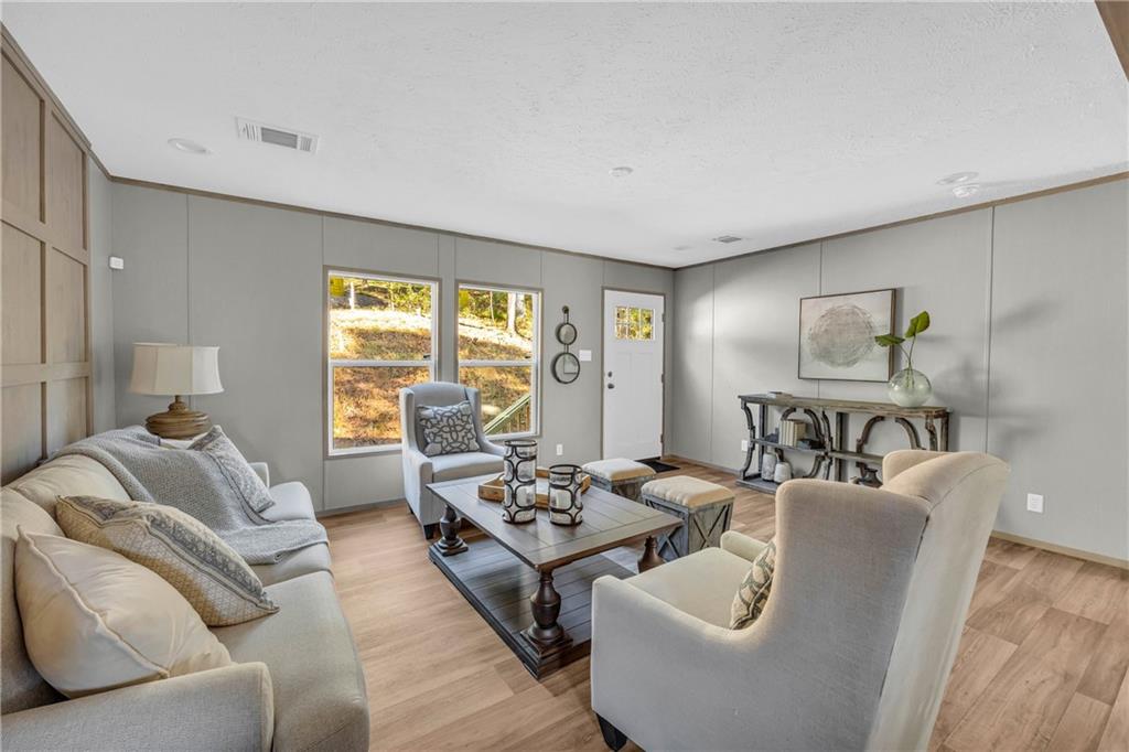 946 Essic Road Ball Ground, GA 30107 - Photo 6 of 45 a living room with furniture and a large window