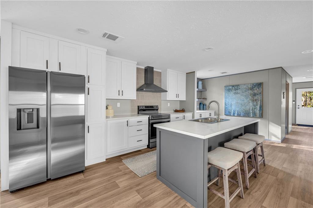 946 Essic Road Ball Ground, GA 30107 - Photo 8 of 45 a kitchen with a sink stainless steel appliances and white cabinets