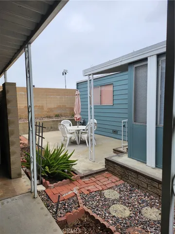a living room with furniture a window and a flat screen tv