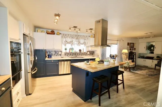 a kitchen with a sink counter top space and stainless steel appliances