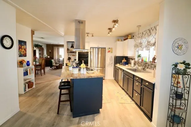 a kitchen with kitchen island a sink stove and refrigerator
