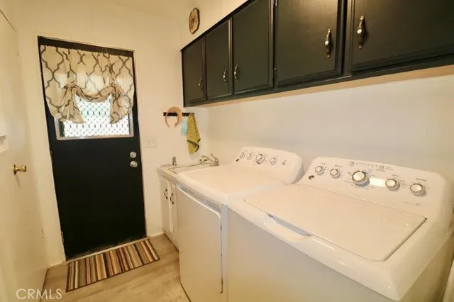 a living room with furniture large window and wooden floor