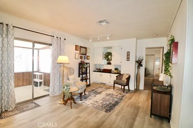 a living room with furniture a window and a flat screen tv