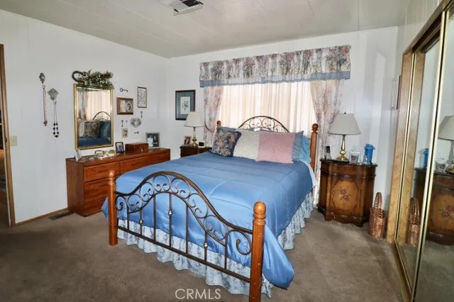 a living room with furniture a flat screen tv and a window