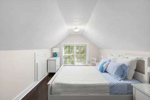 a spacious bedroom with a bed and a window