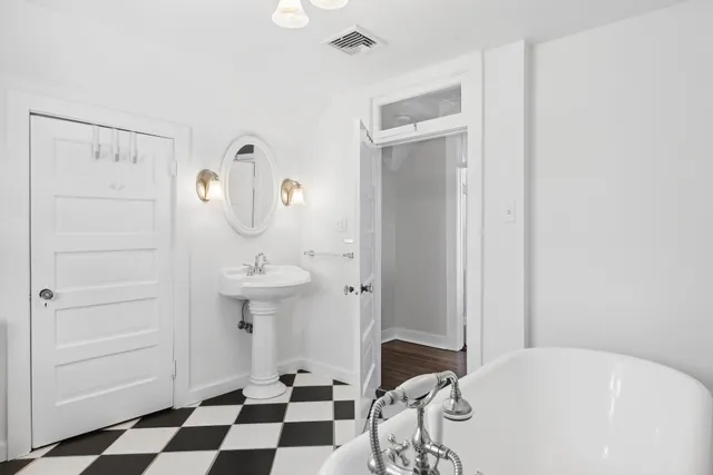 a room with a walk in closet and a bathroom