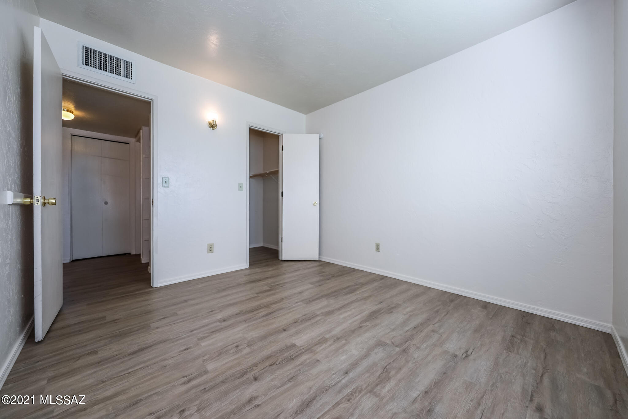 312 East 24th Street, Unit 4 Tucson, AZ 85713 - Photo 7 of 17 a view of an empty room with wooden floor and closet