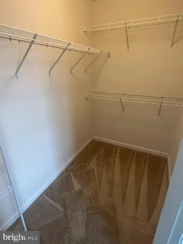 a spacious bathroom with a bathtub sink mirror and toilet