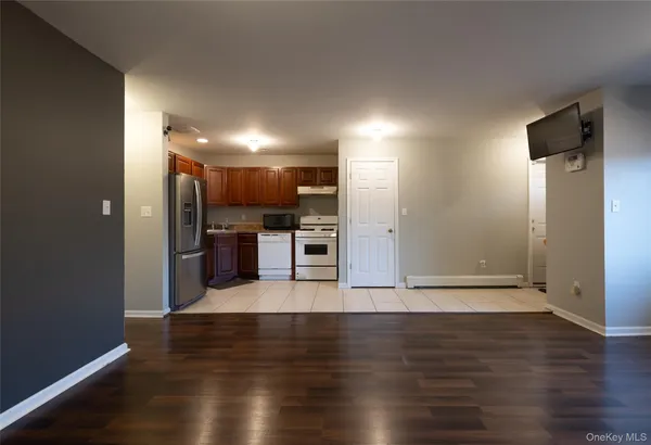 a view of kitchen with cabinets and wooden floor