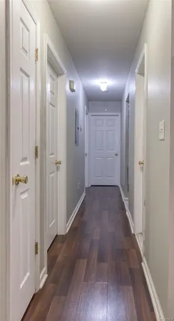a view of hallway with wooden floor