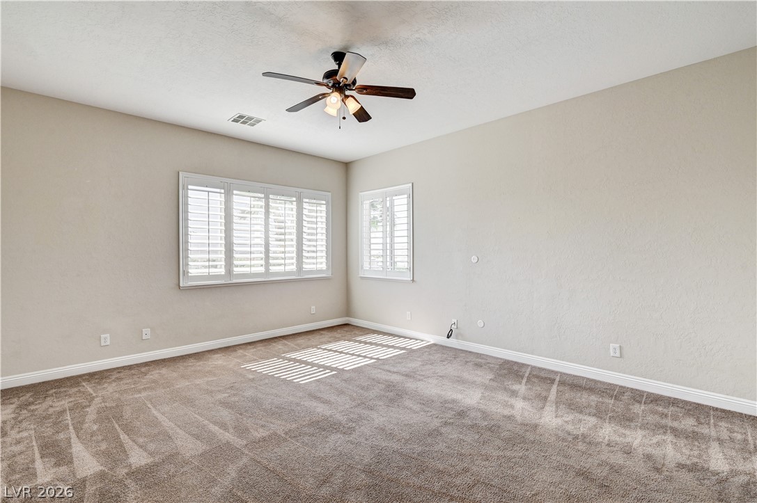 2793 Rosenhearty Drive Henderson, NV 89044 - Photo 45 of 85 This spacious room features ample natural illumination, plush carpeting, and functional plantation shutters.