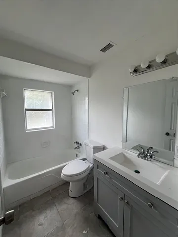 a view of an empty room with a fireplace