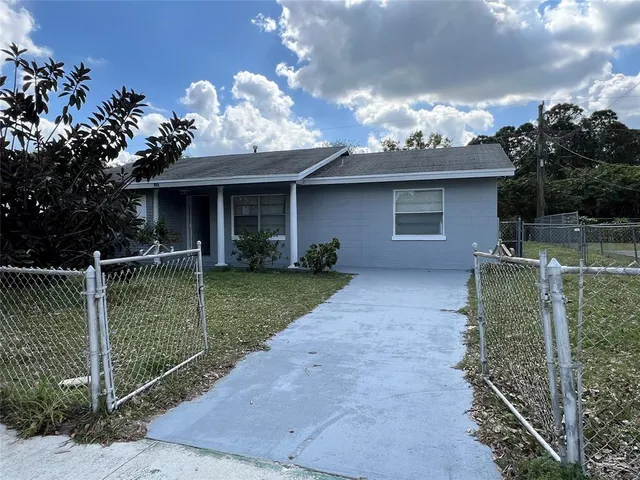 a view of a house with a yard and a garden