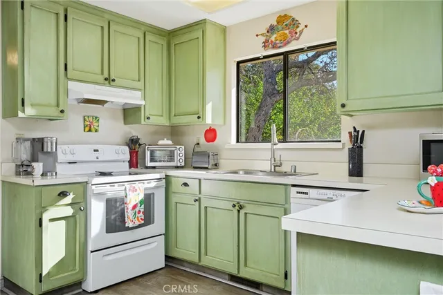 a kitchen with a sink stove and cabinets