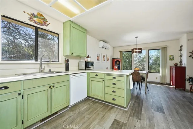 a kitchen with sink cabinets and wooden floor