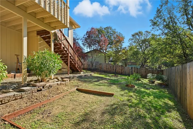 a backyard of a house with lots of green space and fountain