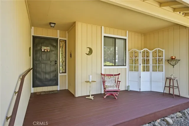 a view of a bedroom with wooden floor and windows
