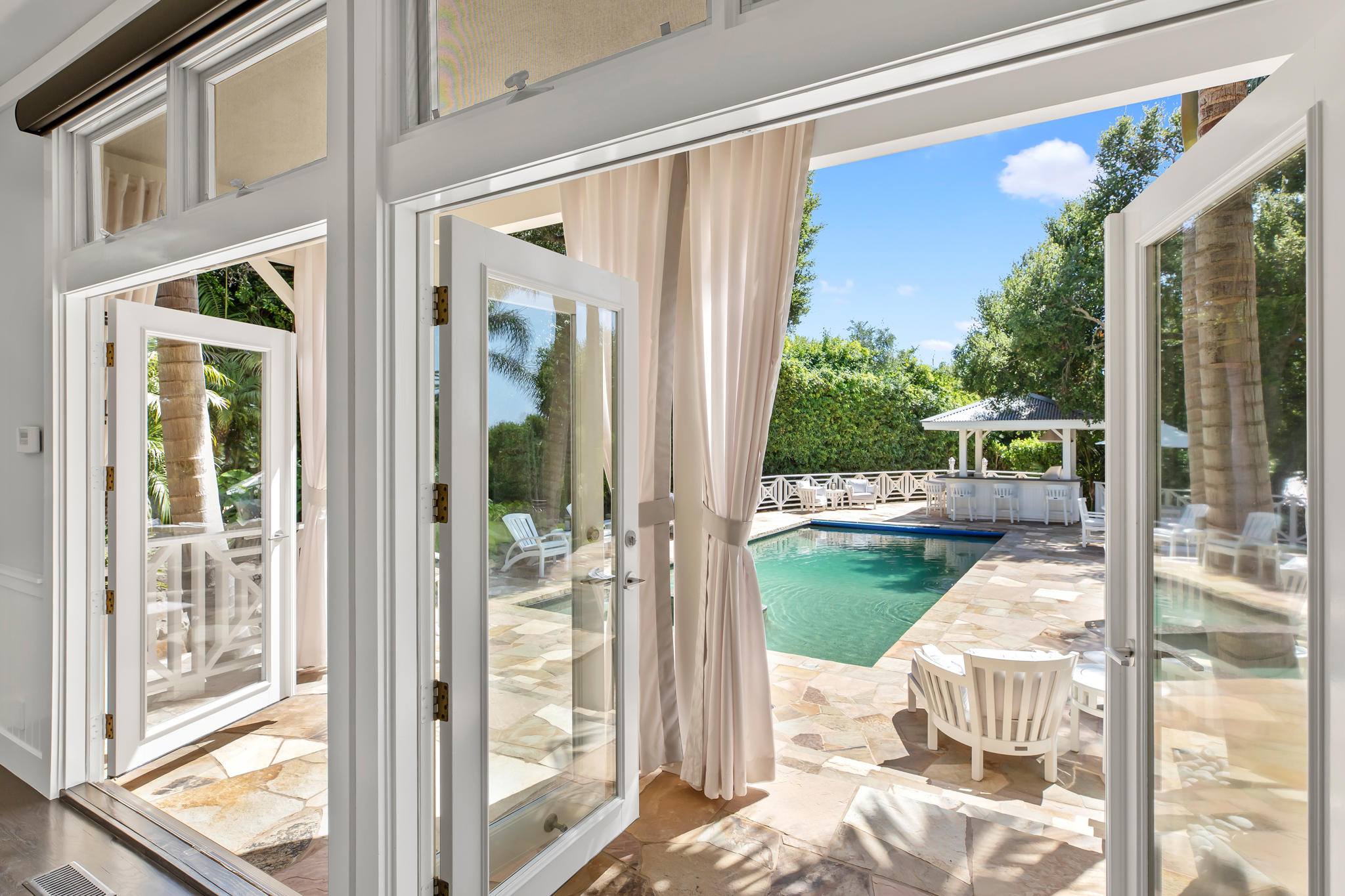 808 Riven Rock Road Santa Barbara, CA 93108 - Photo 9 of 44 a balcony with table and chairs and wooden floor