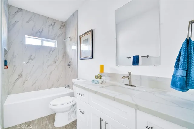 a bathroom with a sink a toilet and a bathtub