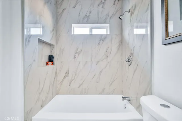 a bathroom with a bathtub and a toilet