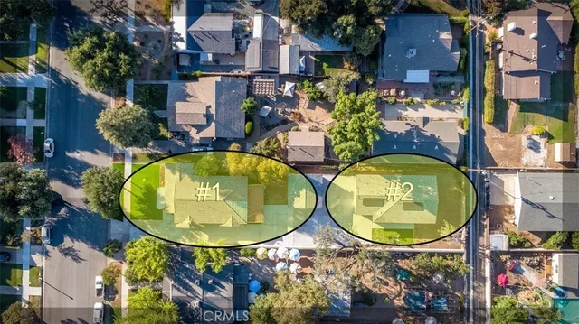 an aerial view of a house with swimming pool and trees