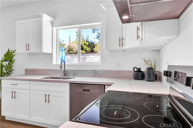 a kitchen with a sink stove and cabinets