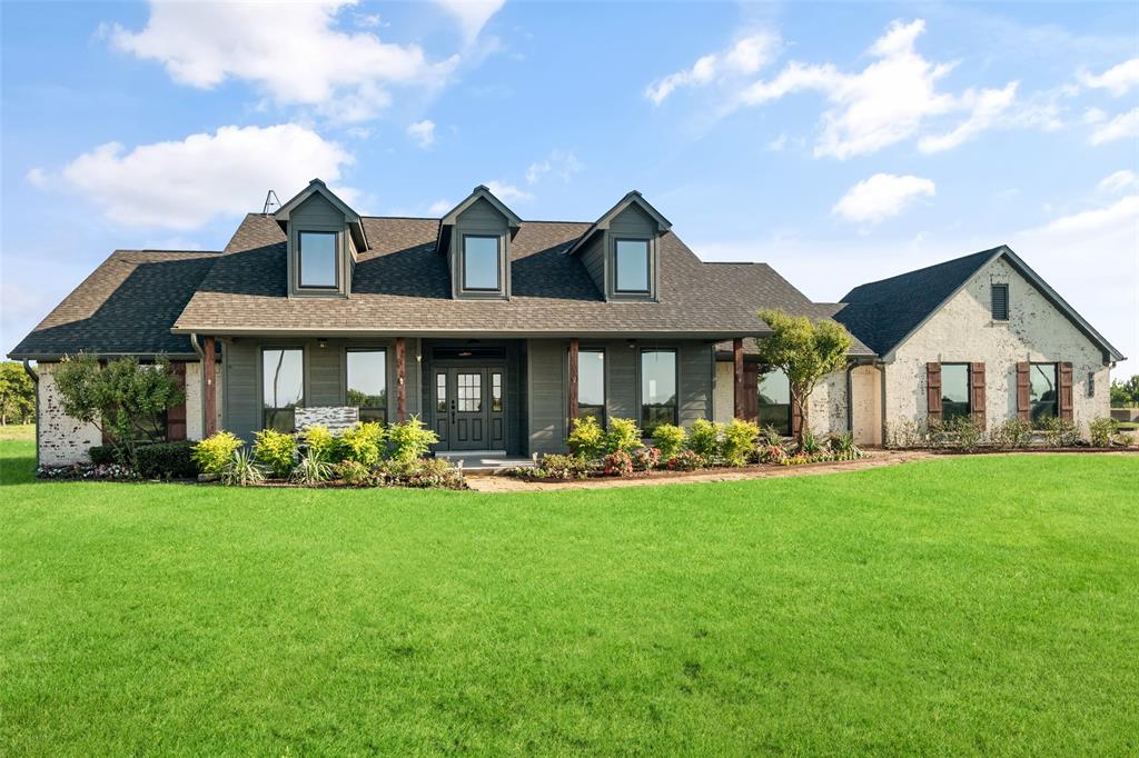 1019 Vaughan Lane Tioga, TX 76271 - Photo 28 of 40 Expansive front lawn with a stone and siding exterior