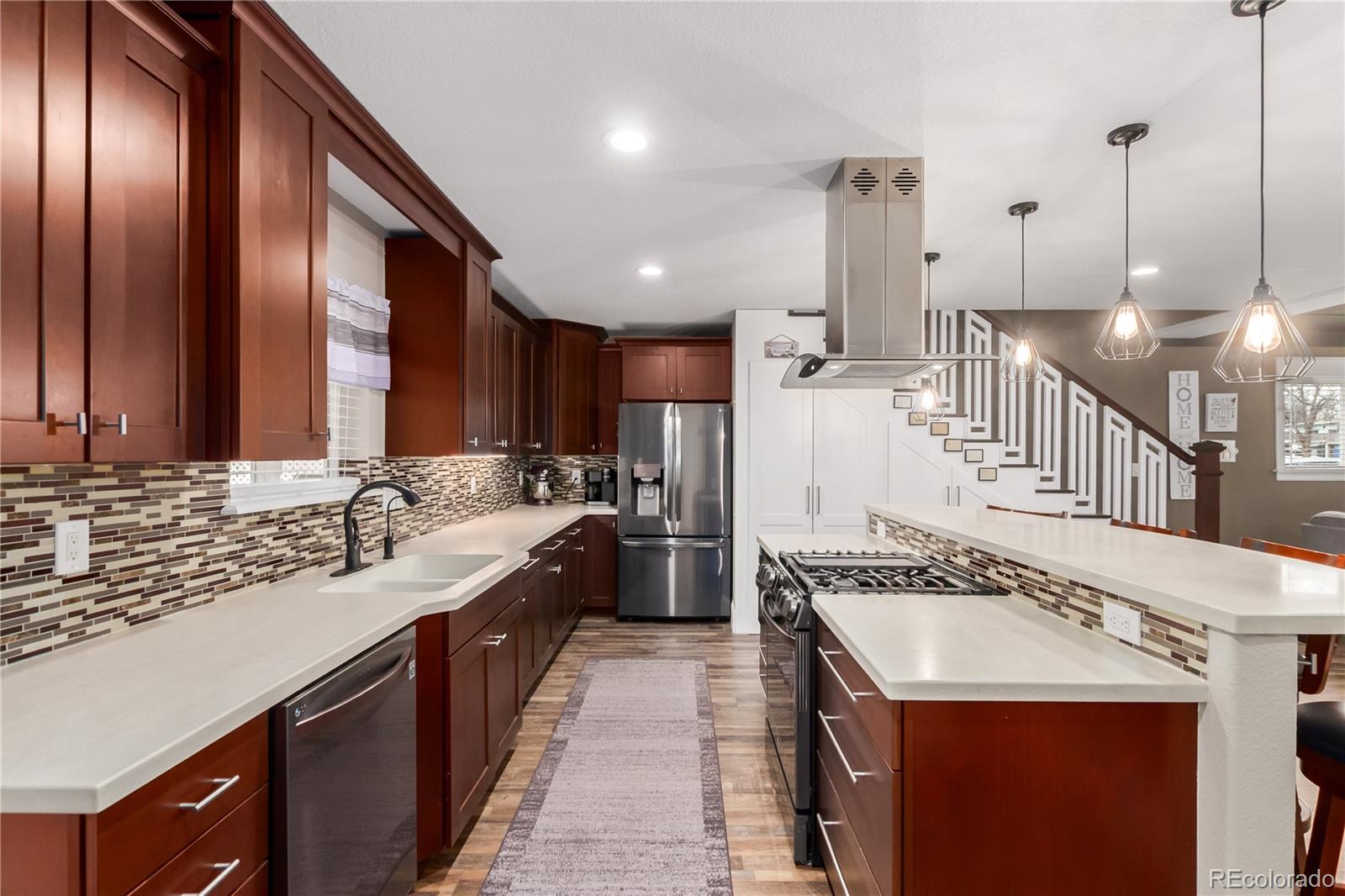 10640 West 46th Avenue Wheat Ridge, CO 80033 - Photo 11 of 46 a kitchen with lots of counter top space and stainless steel appliances