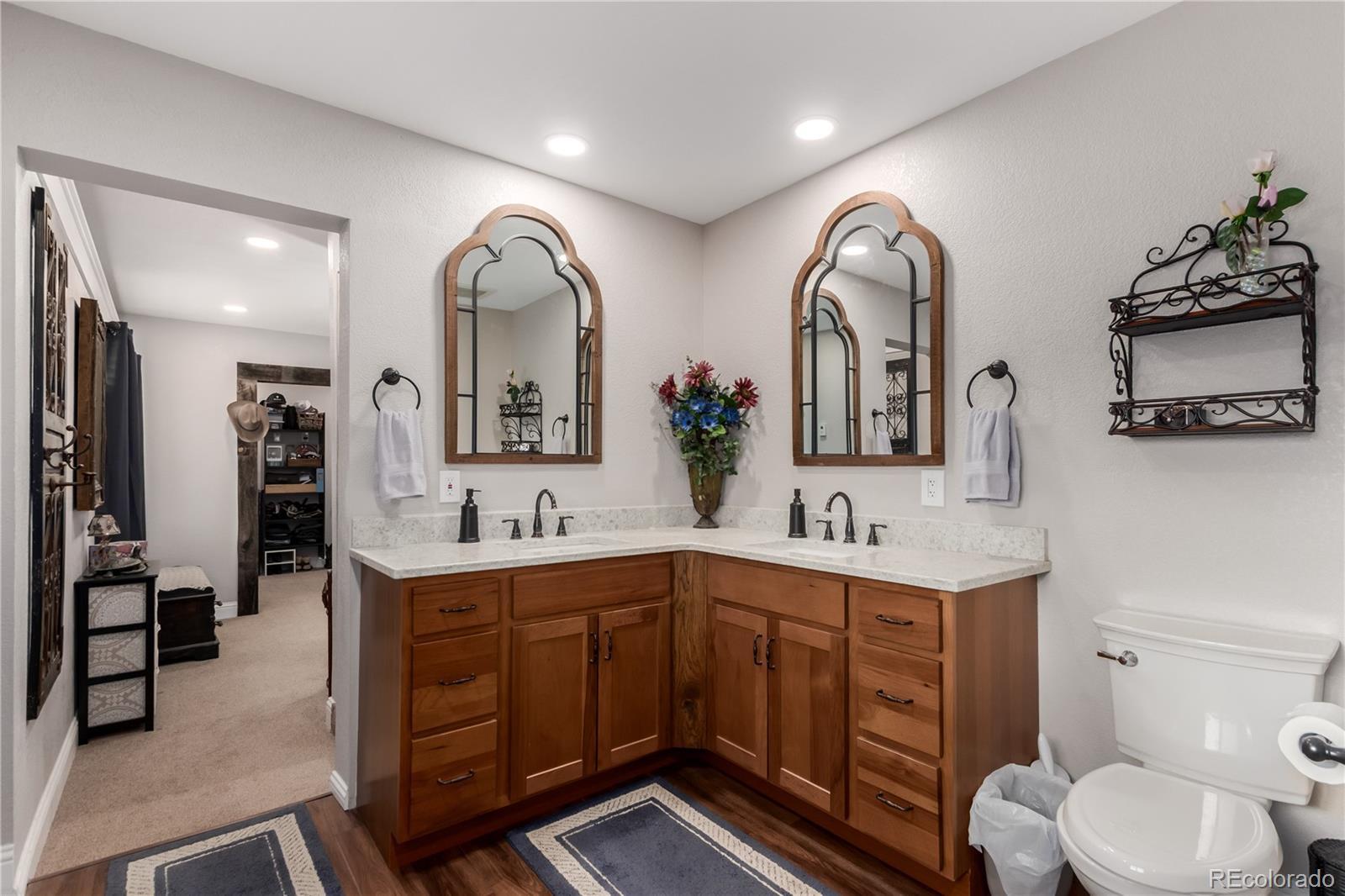 10640 West 46th Avenue Wheat Ridge, CO 80033 - Photo 17 of 46 a spacious bathroom with a double vanity sink and a mirror