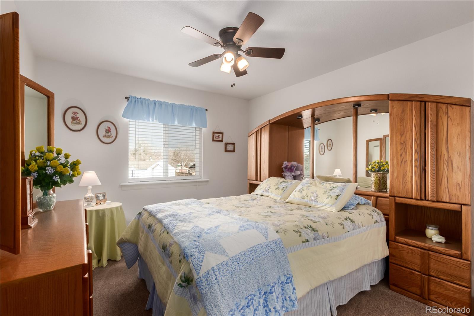 10640 West 46th Avenue Wheat Ridge, CO 80033 - Photo 22 of 46 a bedroom with a bed and a chandelier