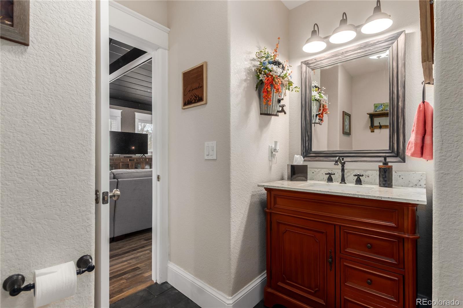 10640 West 46th Avenue Wheat Ridge, CO 80033 - Photo 26 of 46 a bathroom with a sink vanity and mirror