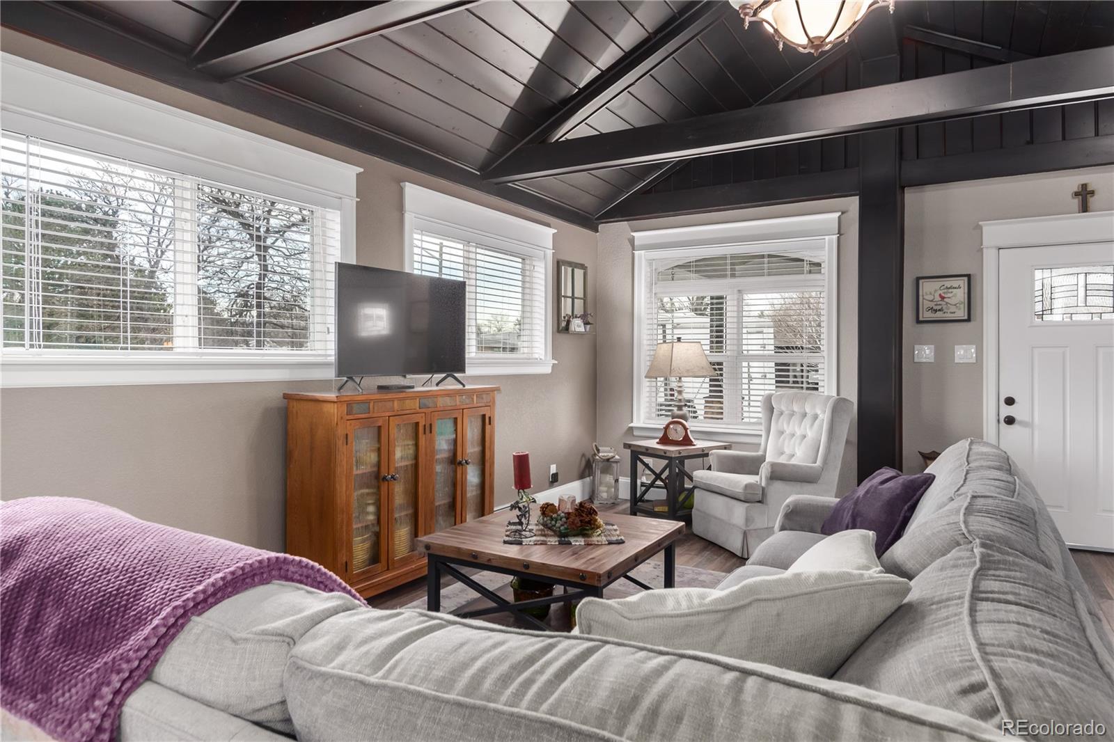 10640 West 46th Avenue Wheat Ridge, CO 80033 - Photo 7 of 46 a living room with furniture and a flat screen tv