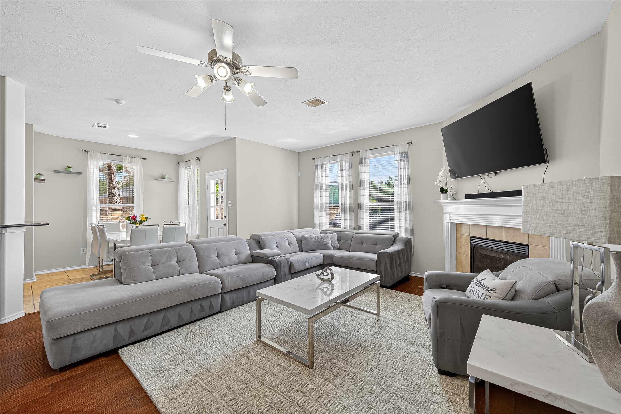 a living room with furniture a flat screen tv and a fireplace