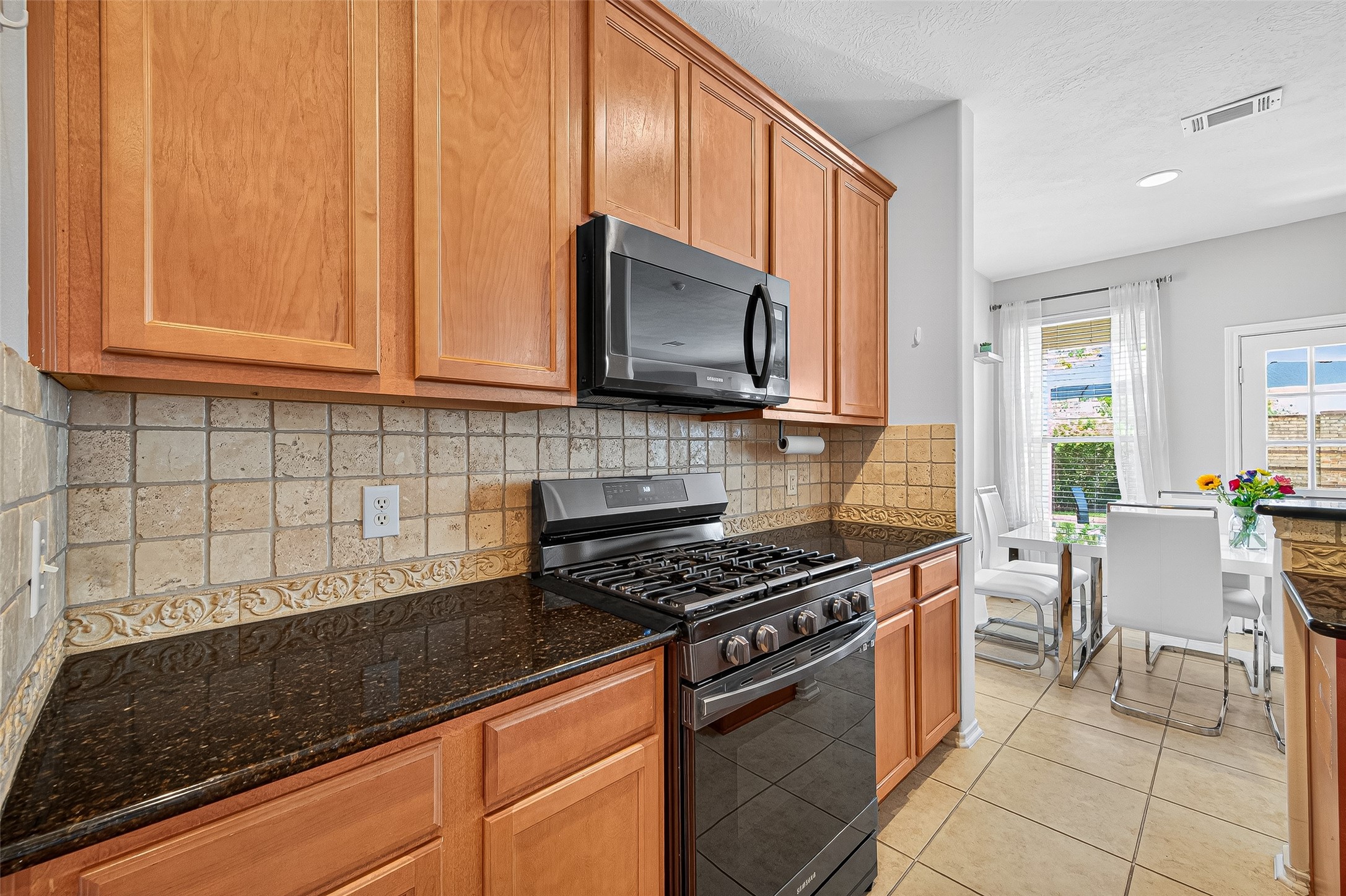6230 Hollydale Ridge Lane Katy, TX 77494 - Photo 11 of 41 a kitchen with stainless steel appliances granite countertop a stove a sink and a microwave