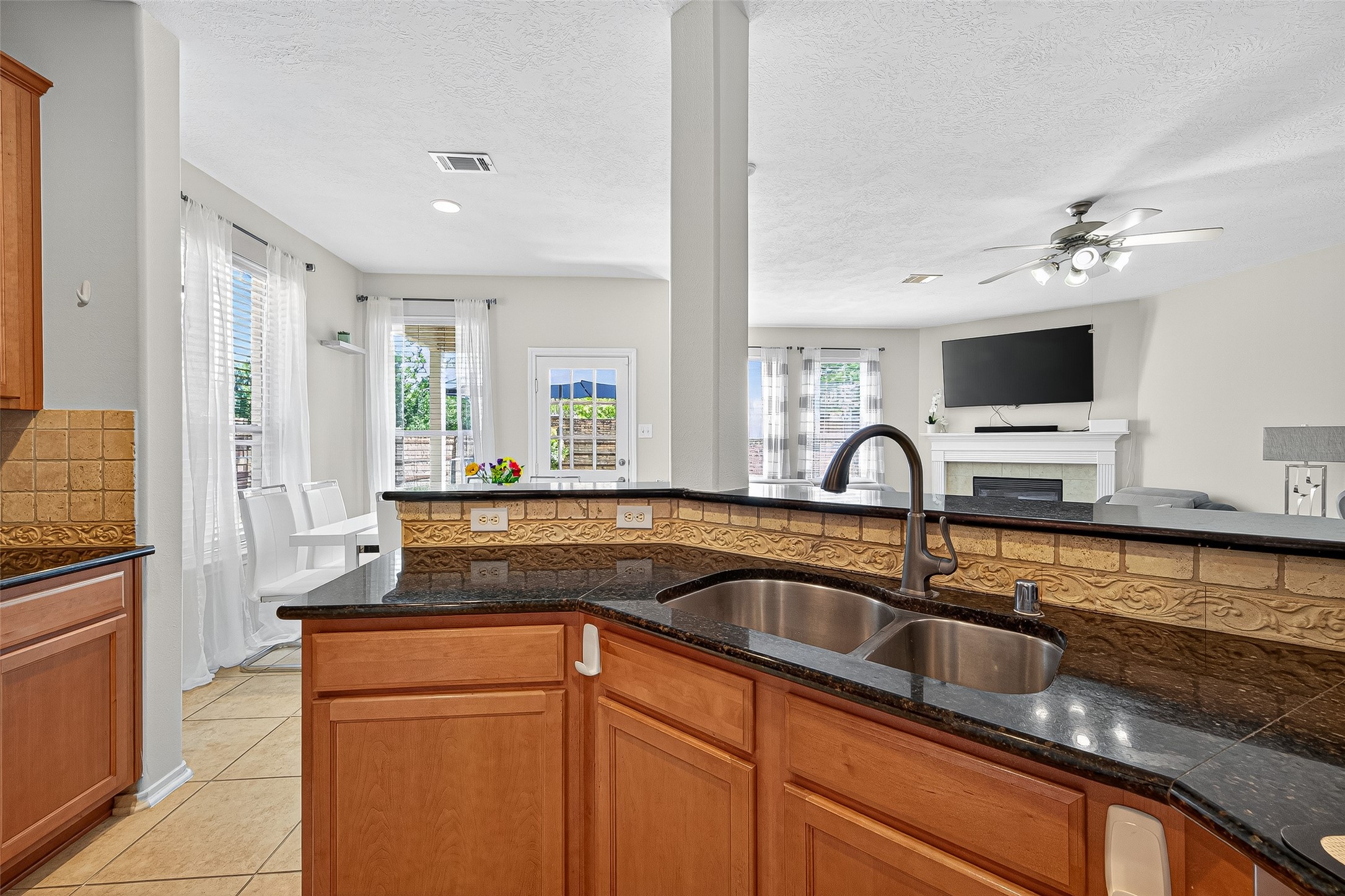 6230 Hollydale Ridge Lane Katy, TX 77494 - Photo 13 of 41 a kitchen with granite countertop a sink and a stove top oven