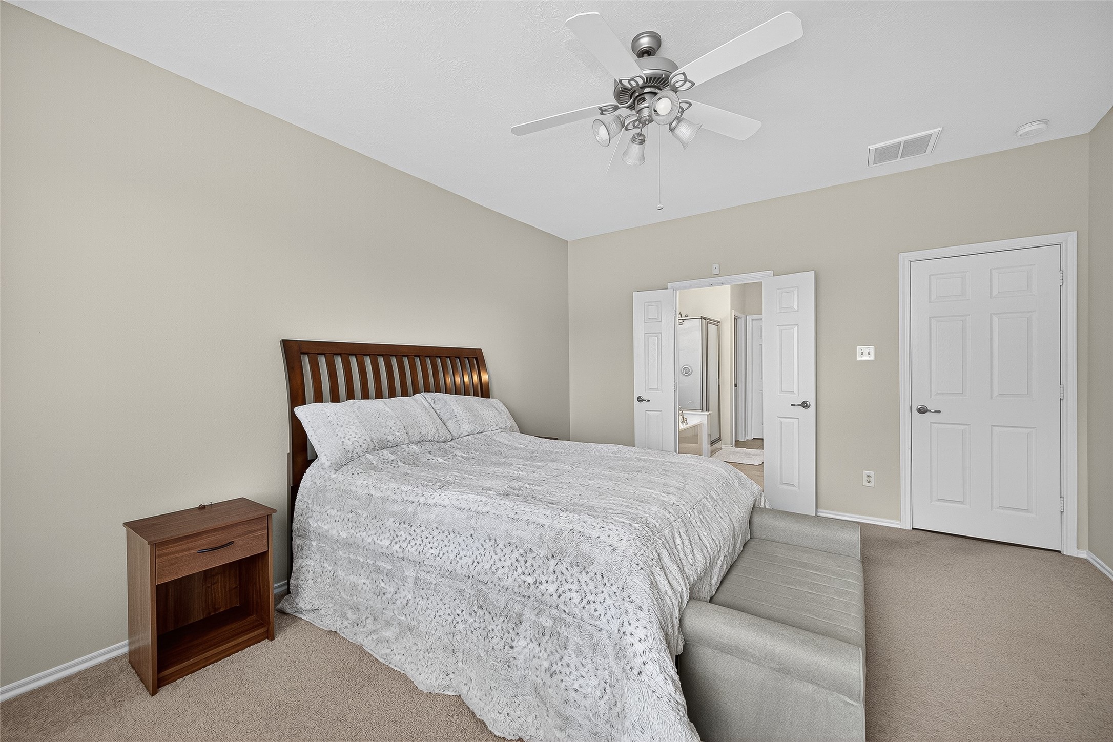 6230 Hollydale Ridge Lane Katy, TX 77494 - Photo 20 of 41 a spacious bedroom with a bed and a chandelier