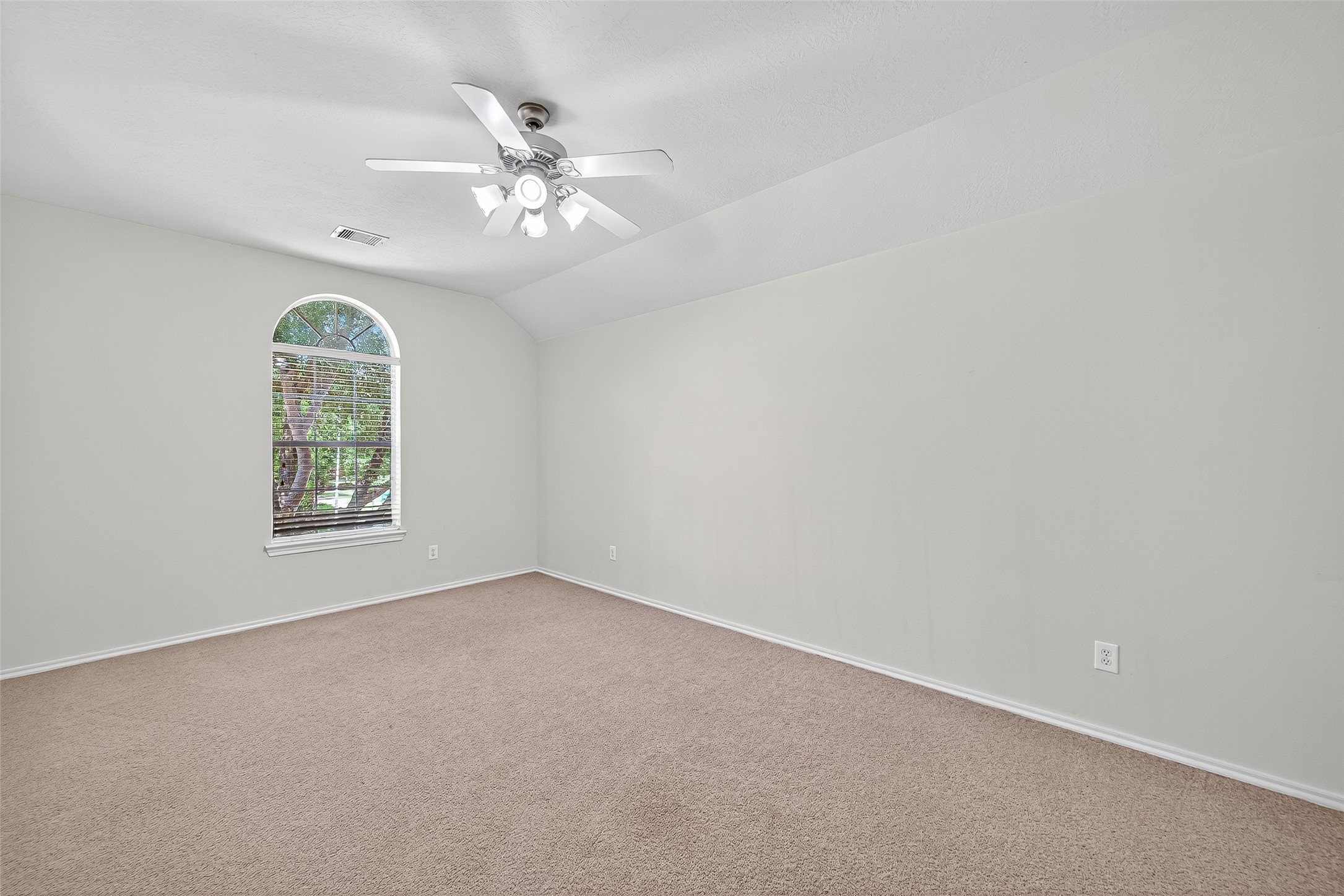 6230 Hollydale Ridge Lane Katy, TX 77494 - Photo 26 of 41 an empty room with a chandelier fan and window
