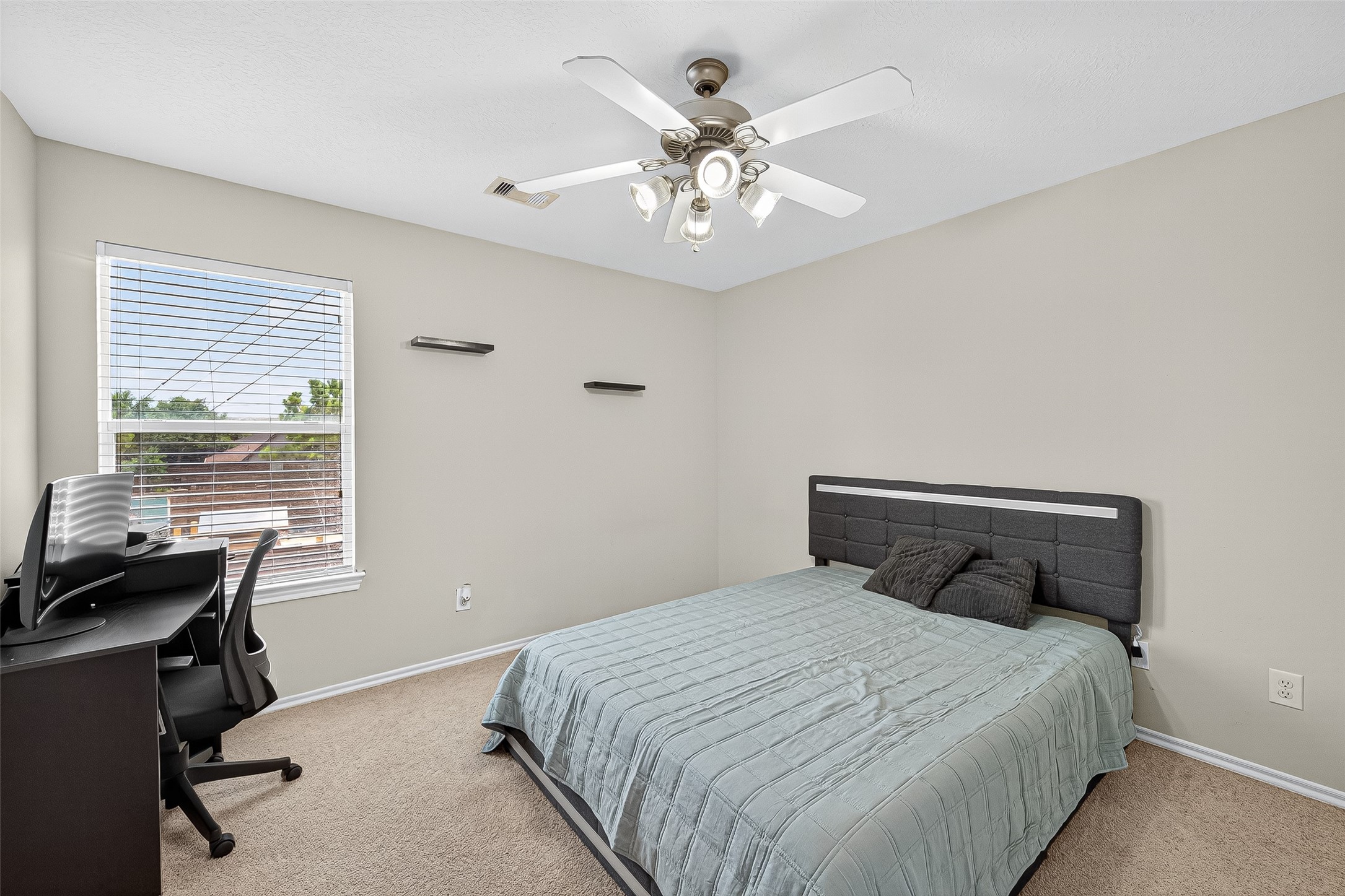 6230 Hollydale Ridge Lane Katy, TX 77494 - Photo 27 of 41 a bedroom with a bed and a table