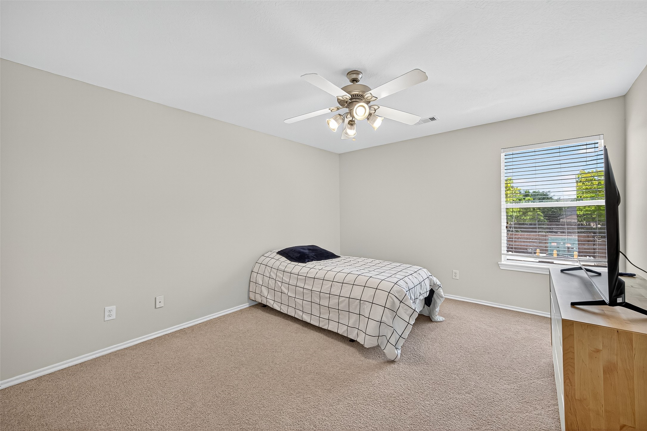 6230 Hollydale Ridge Lane Katy, TX 77494 - Photo 30 of 41 a room with a bed chandelier and a window