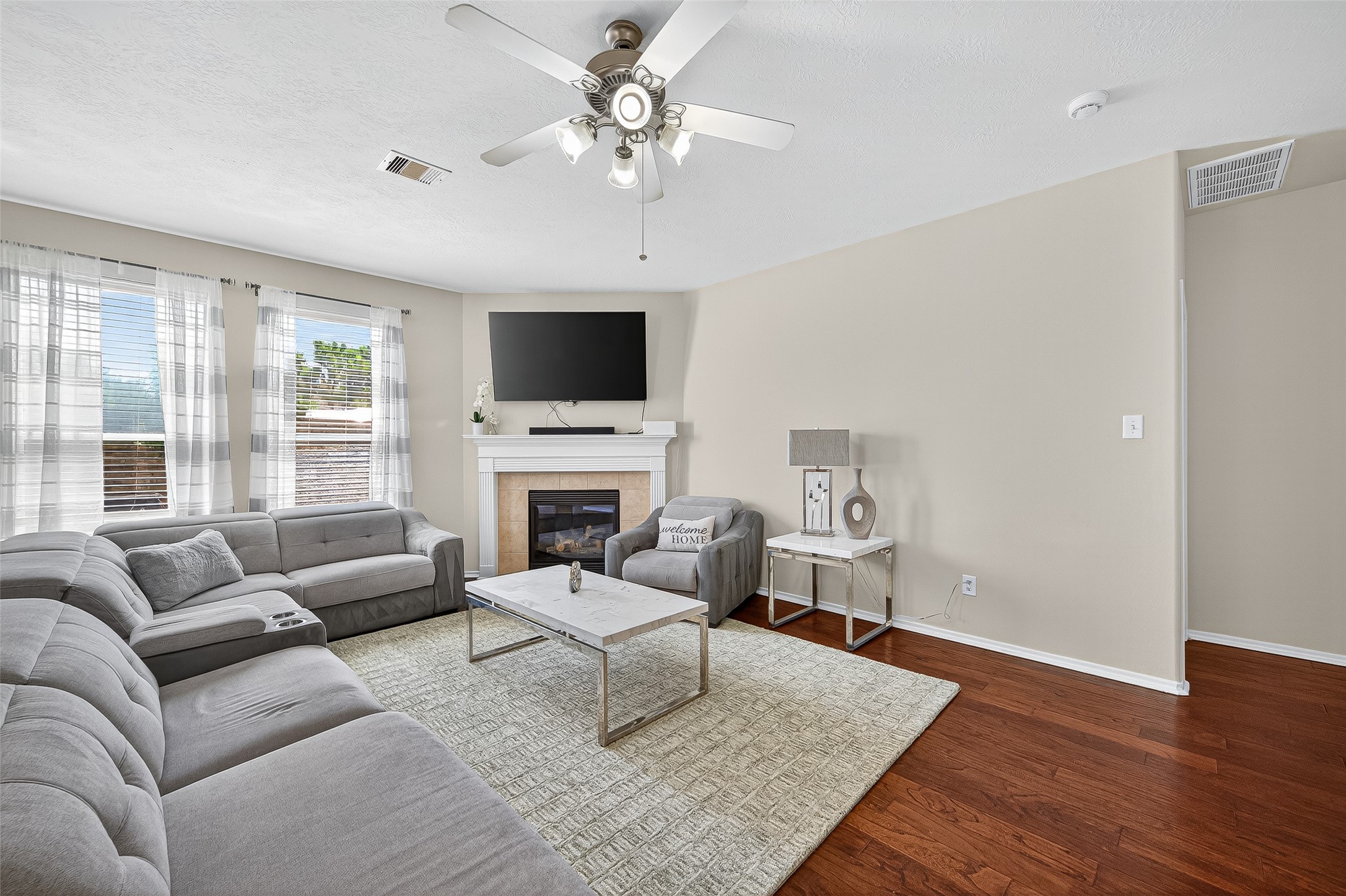 6230 Hollydale Ridge Lane Katy, TX 77494 - Photo 6 of 41 a living room with furniture a fireplace and a flat screen tv