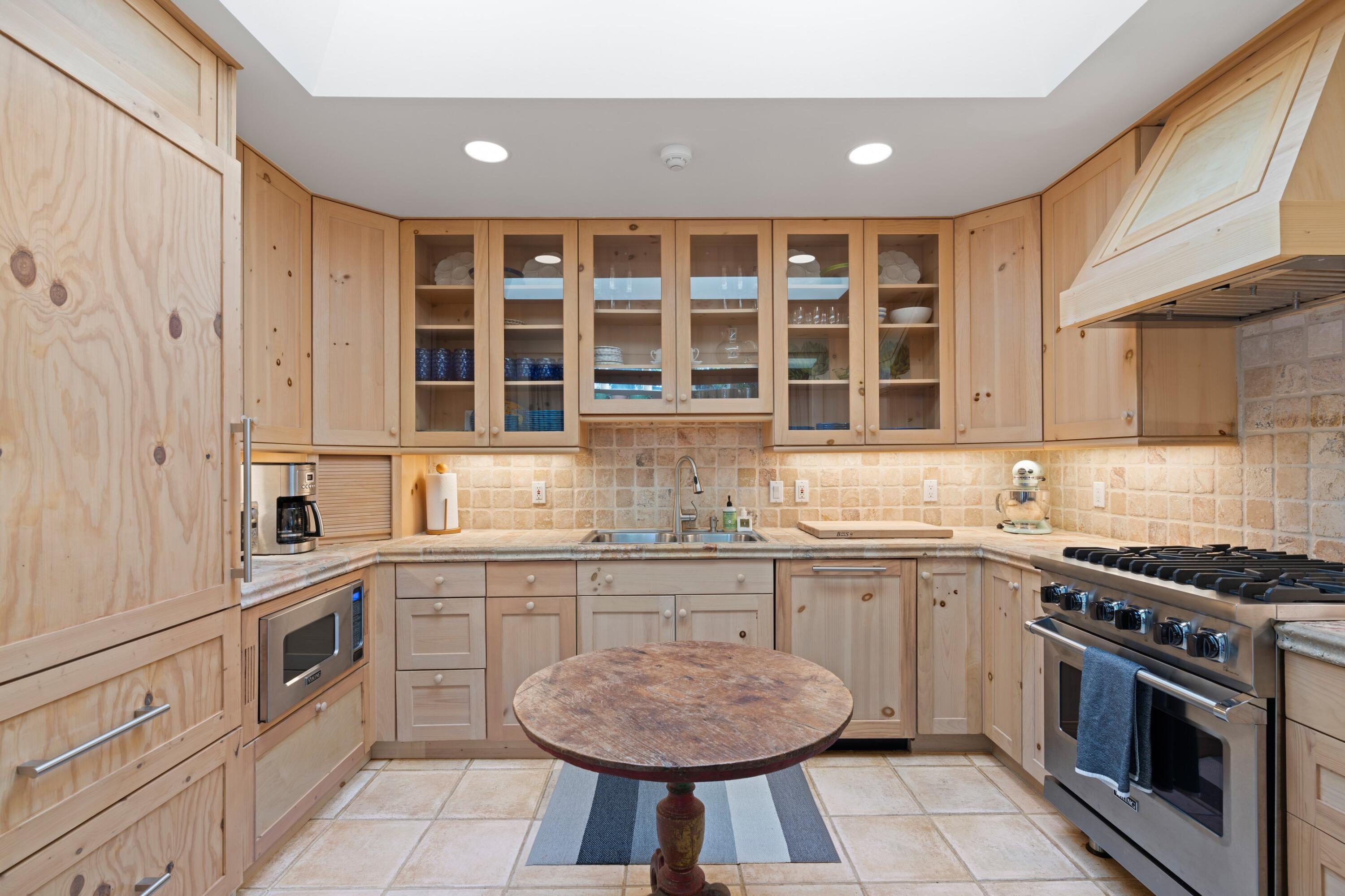 240 Celestial Way, Unit 10 Juno Beach, FL 33408 - Photo 18 of 40 a kitchen with stainless steel appliances granite countertop a stove and a sink
